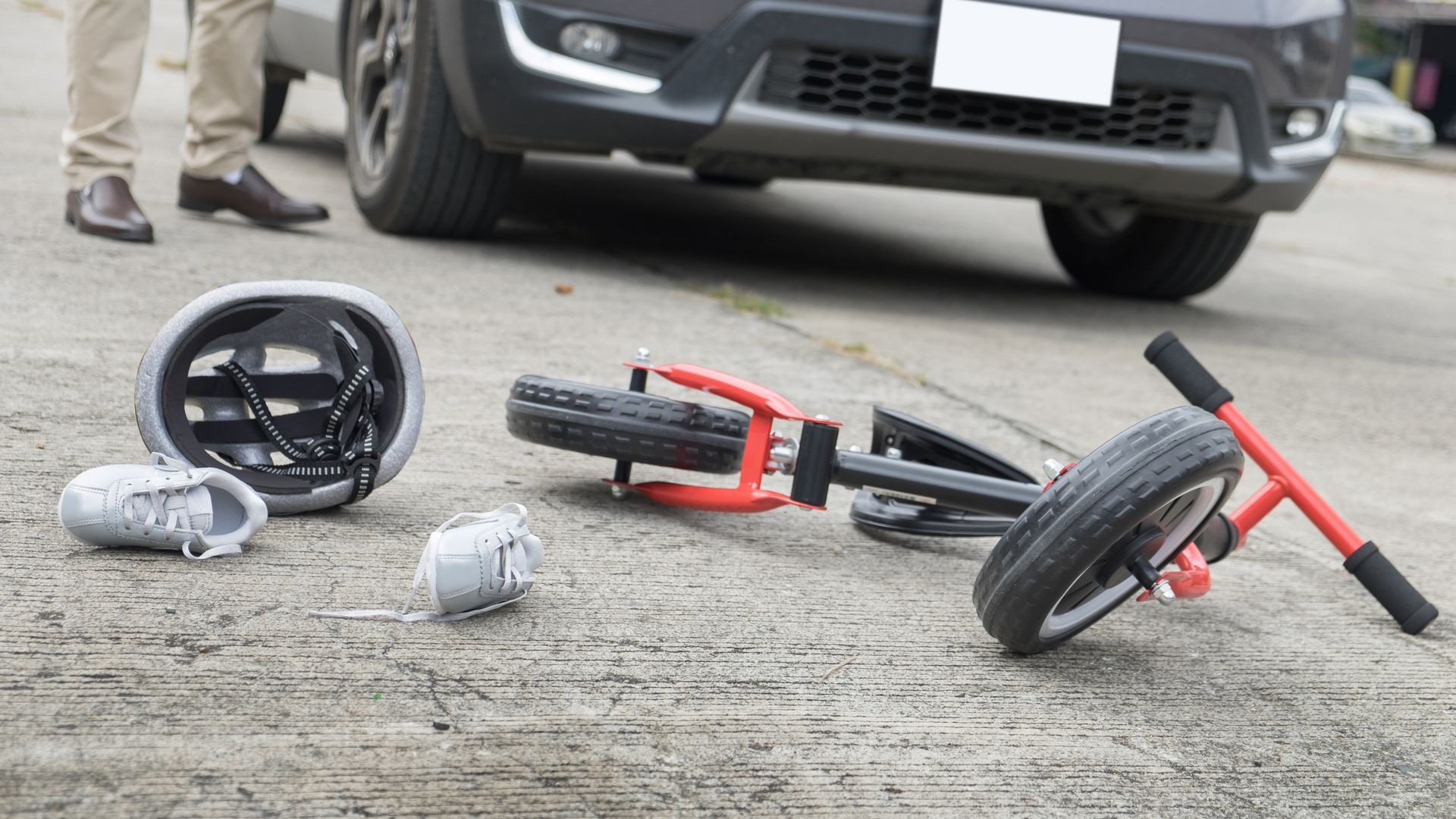 scared and stressed desperate drunken driver and bottle of beer in front of automobile crash car with child bike after traffic accident in city road